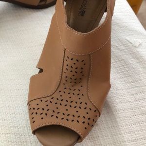 Peep toe shoe with cutout design on front.